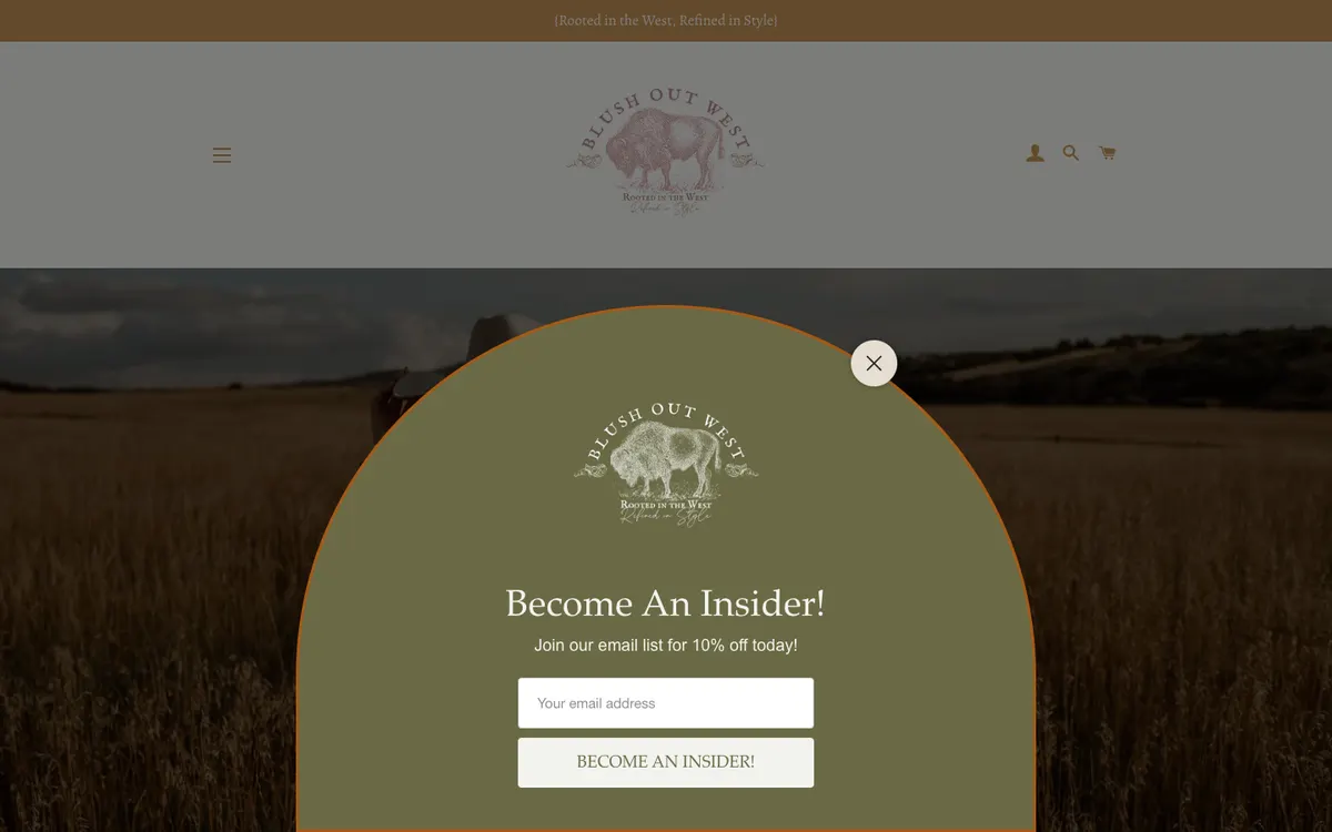 Top of the Blush Out West homepage with a tan announcement bar reading Rooted in the West, Refined in Style inside curly braces, above a large bison logo and a newsletter popup covering the hero photo